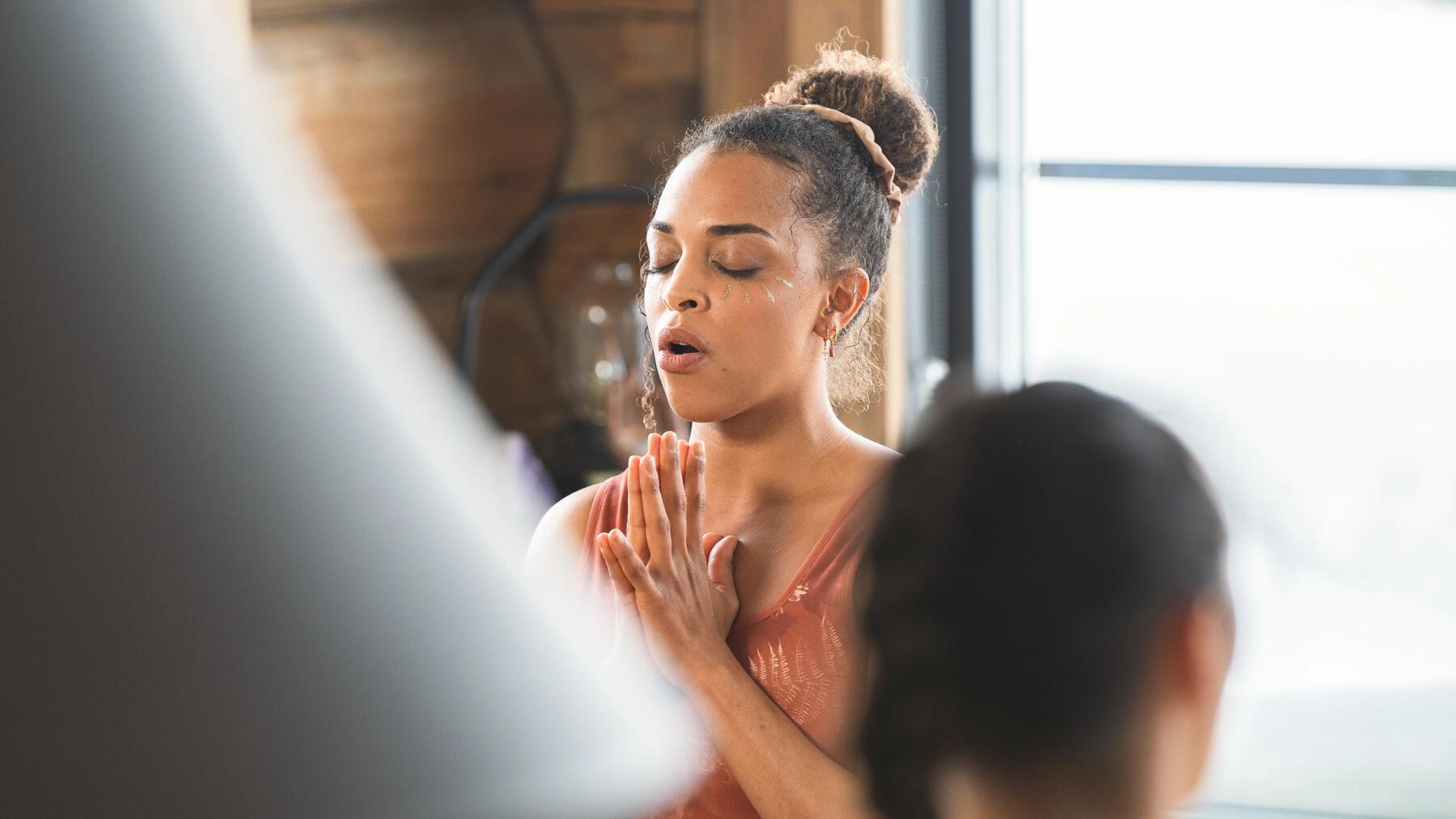 two women meditating indoors