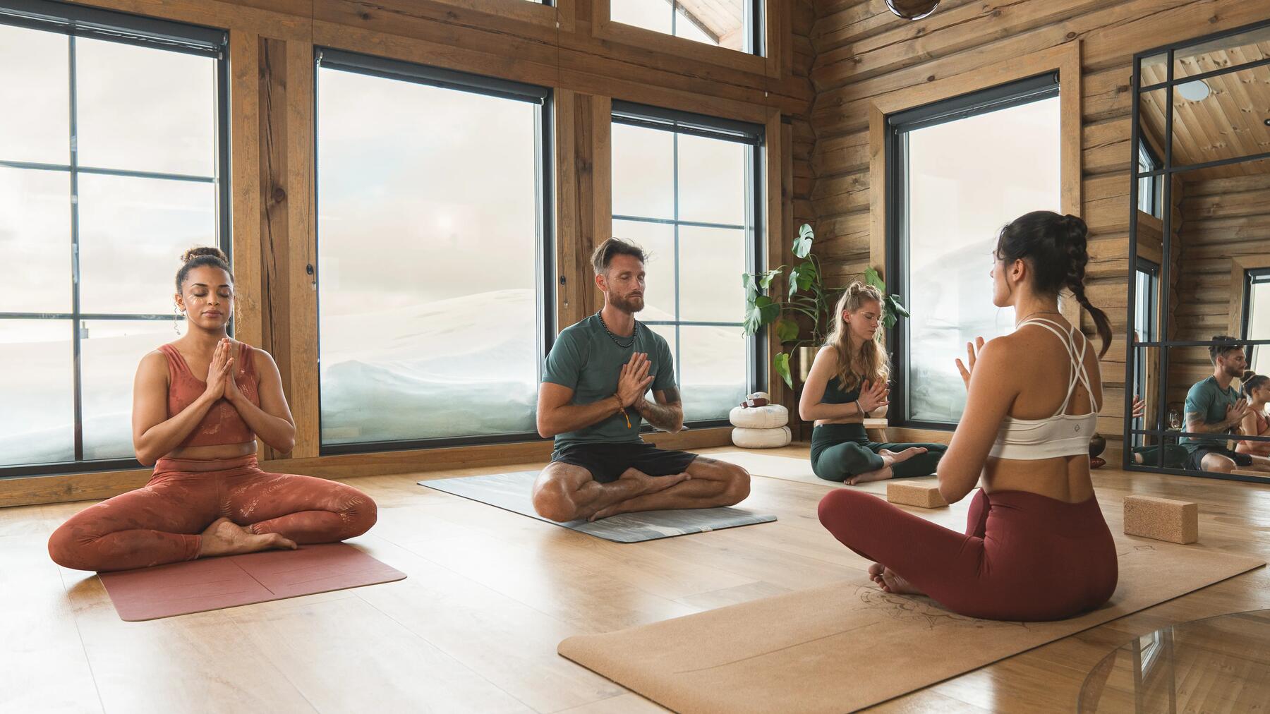 man and woman meditating indoors