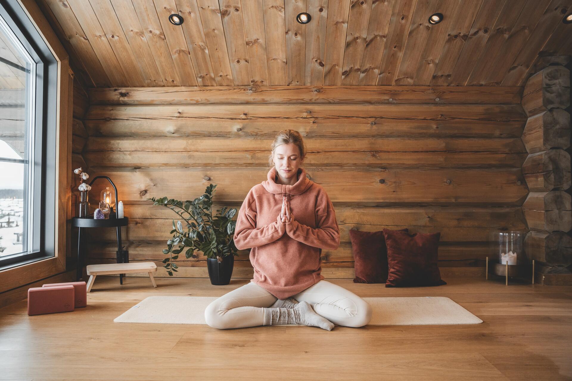 femme sur un tapis de yoga, à la maison