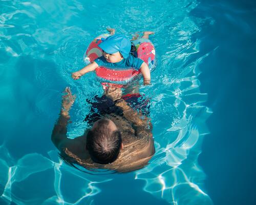 Baby in a pool with his mom