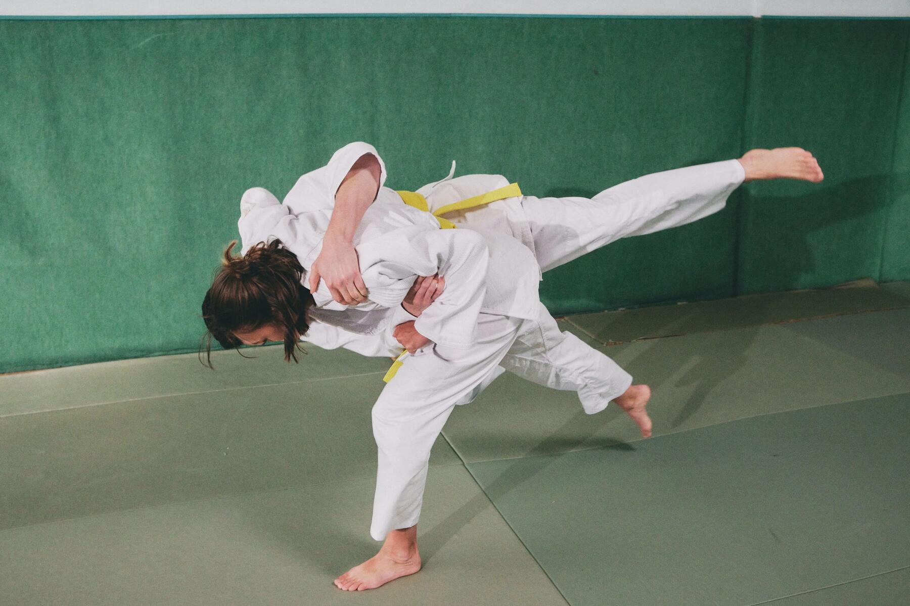 two men doing karate kicks
