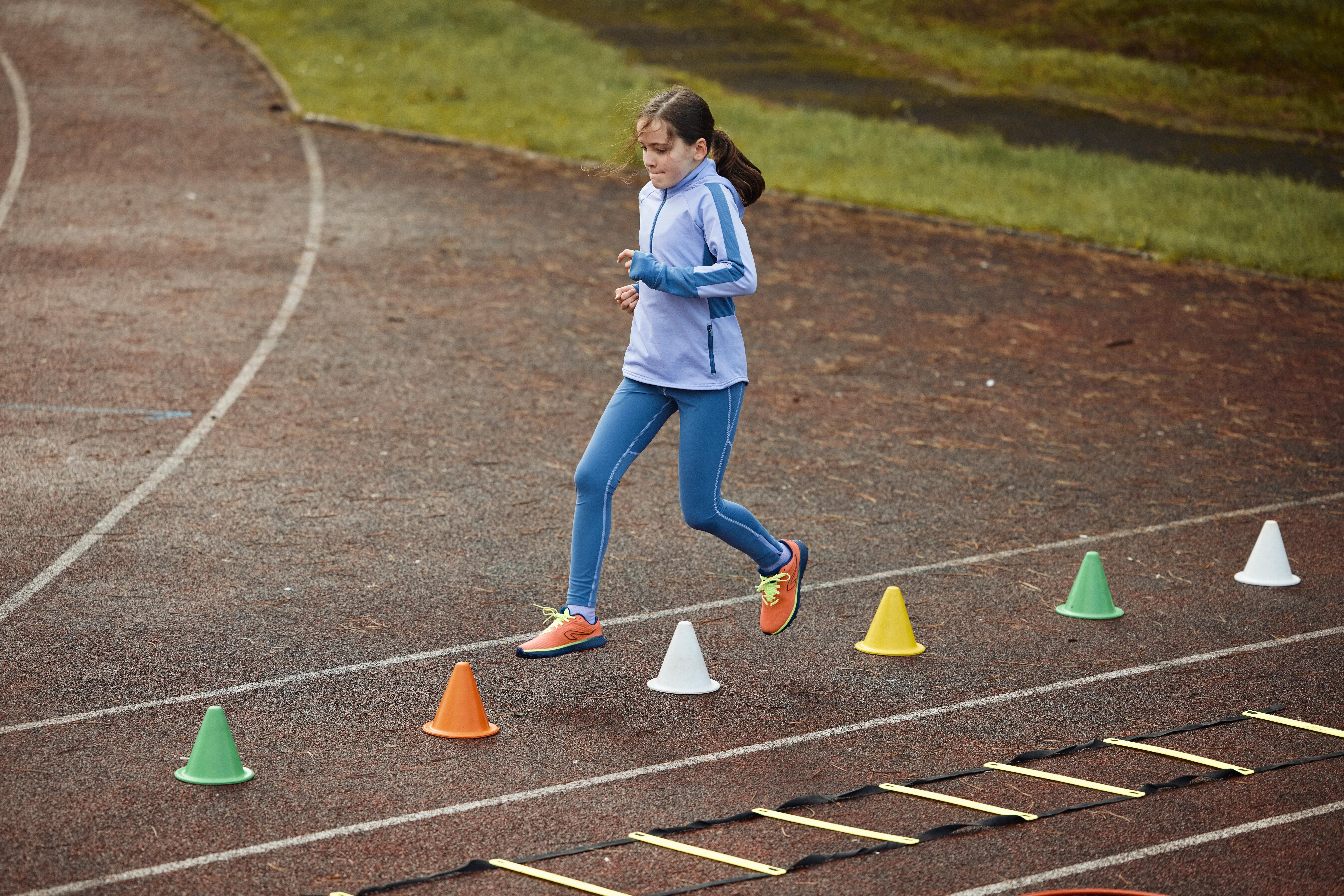 Girl completing an agility ladder drill