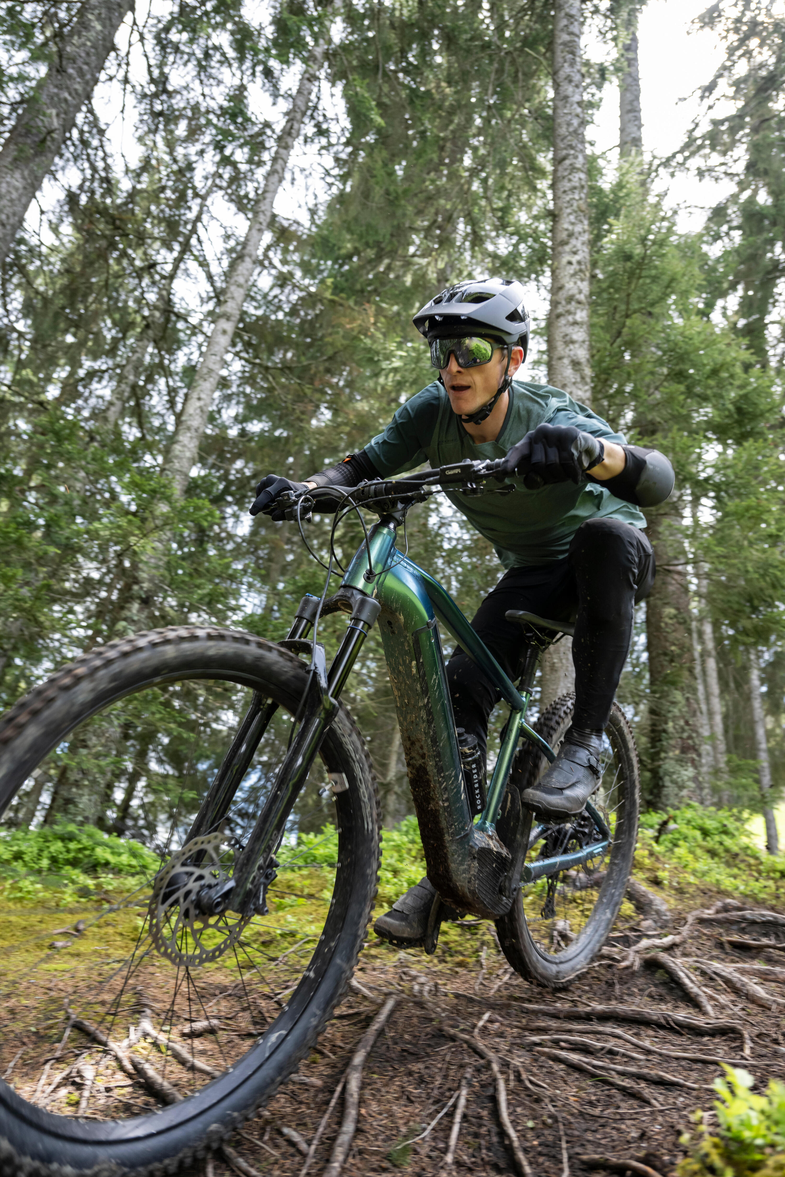 A man mountain biking in the forest