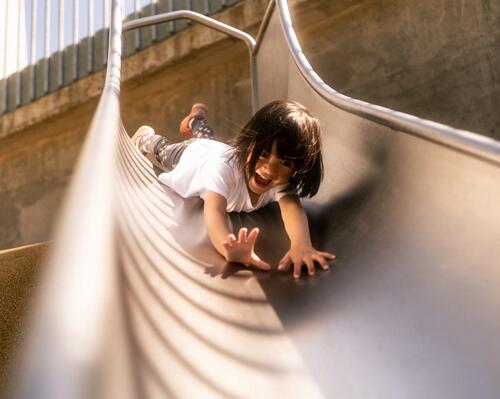 a little girl on a playground slide