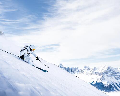 person downhill skiing