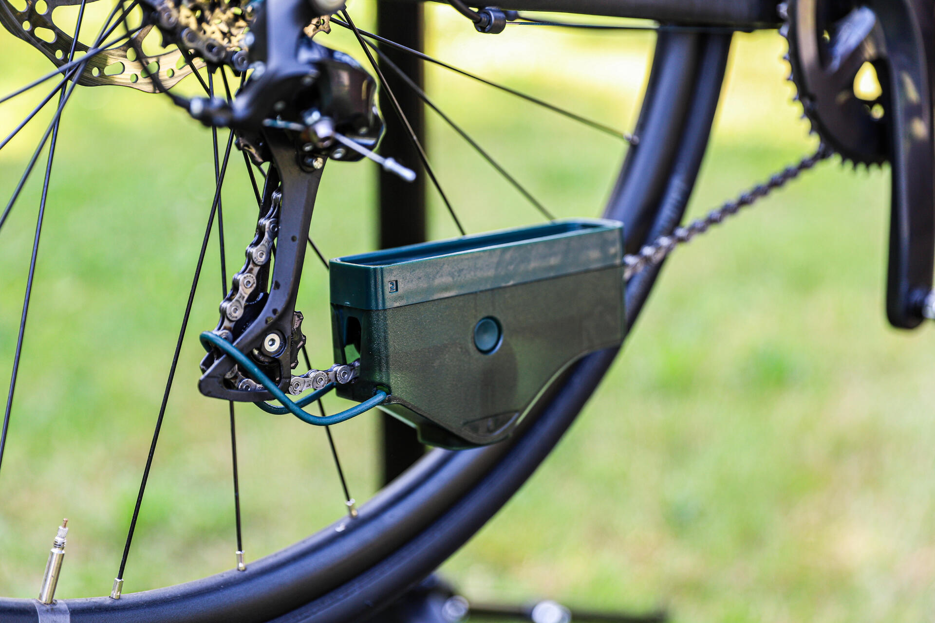 A bike chain cleaning tool attached to a a bike chain.