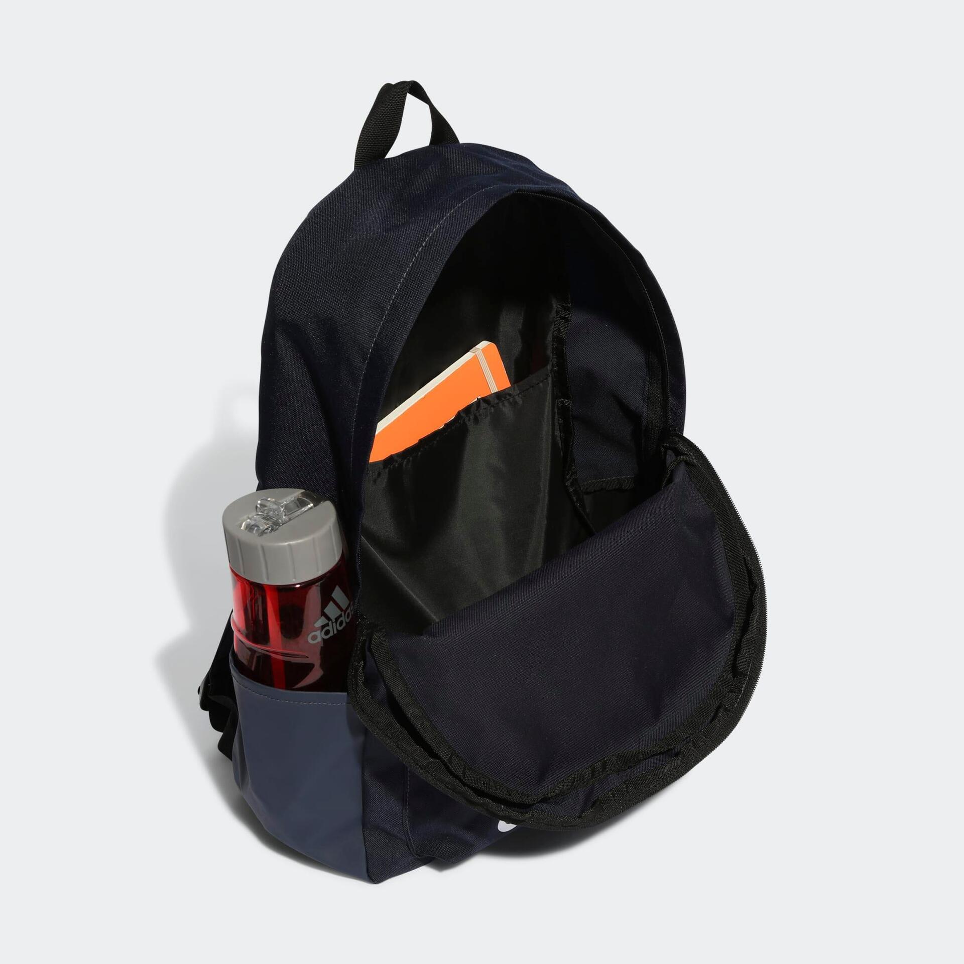 Classic Adidas backpack in navy displaying the inside of the bag with a book and water bottle in the side pocket