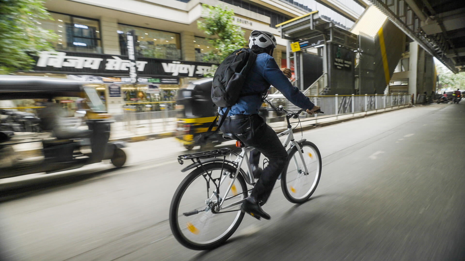Mann auf dem Fahrrad mit Fahrradhelm und einem Rucksack auf dem Weg zur Arbeit