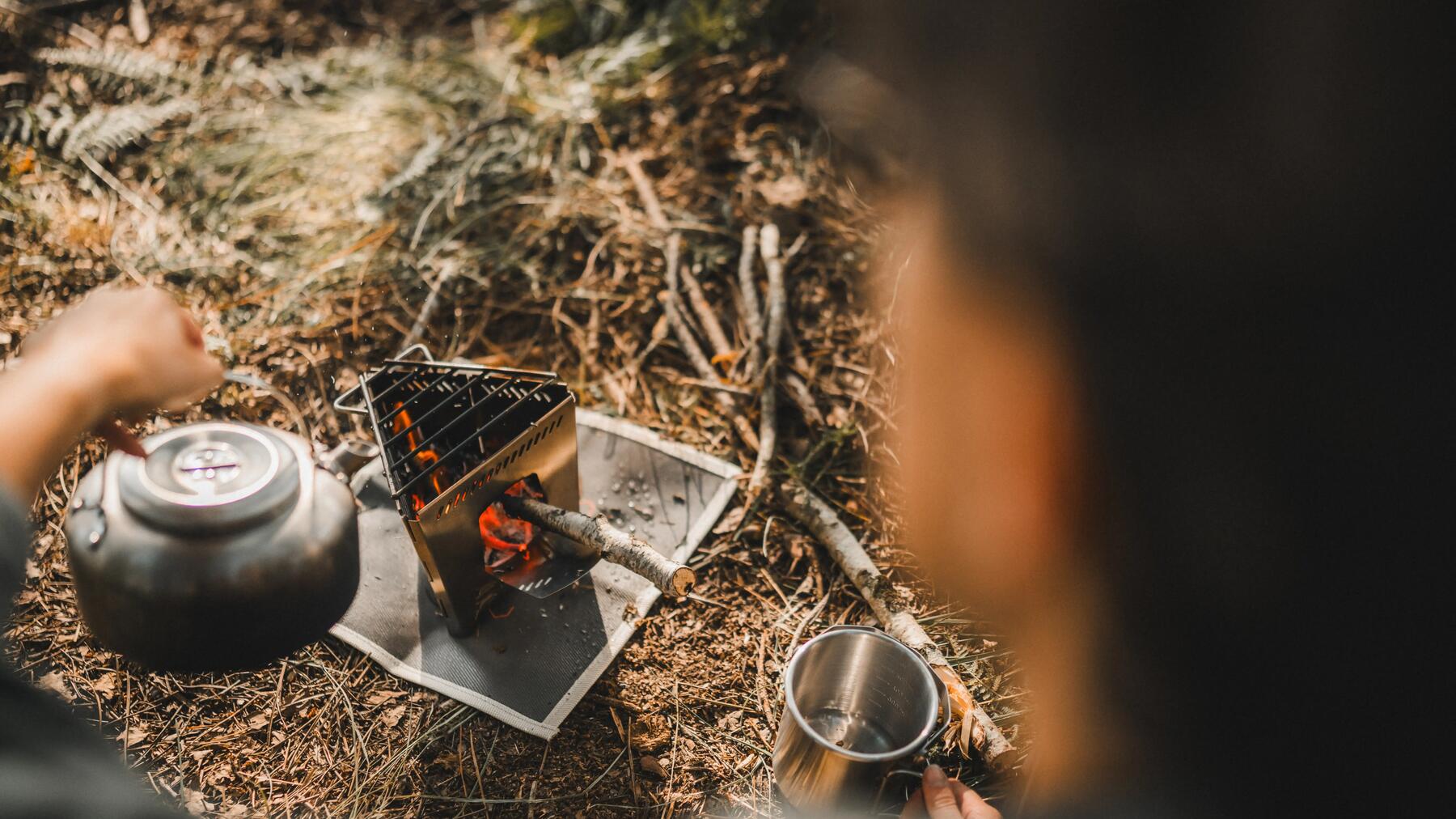 Woman camping and wearing a headlamp