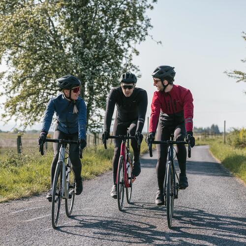 Image of three persons on bike on road