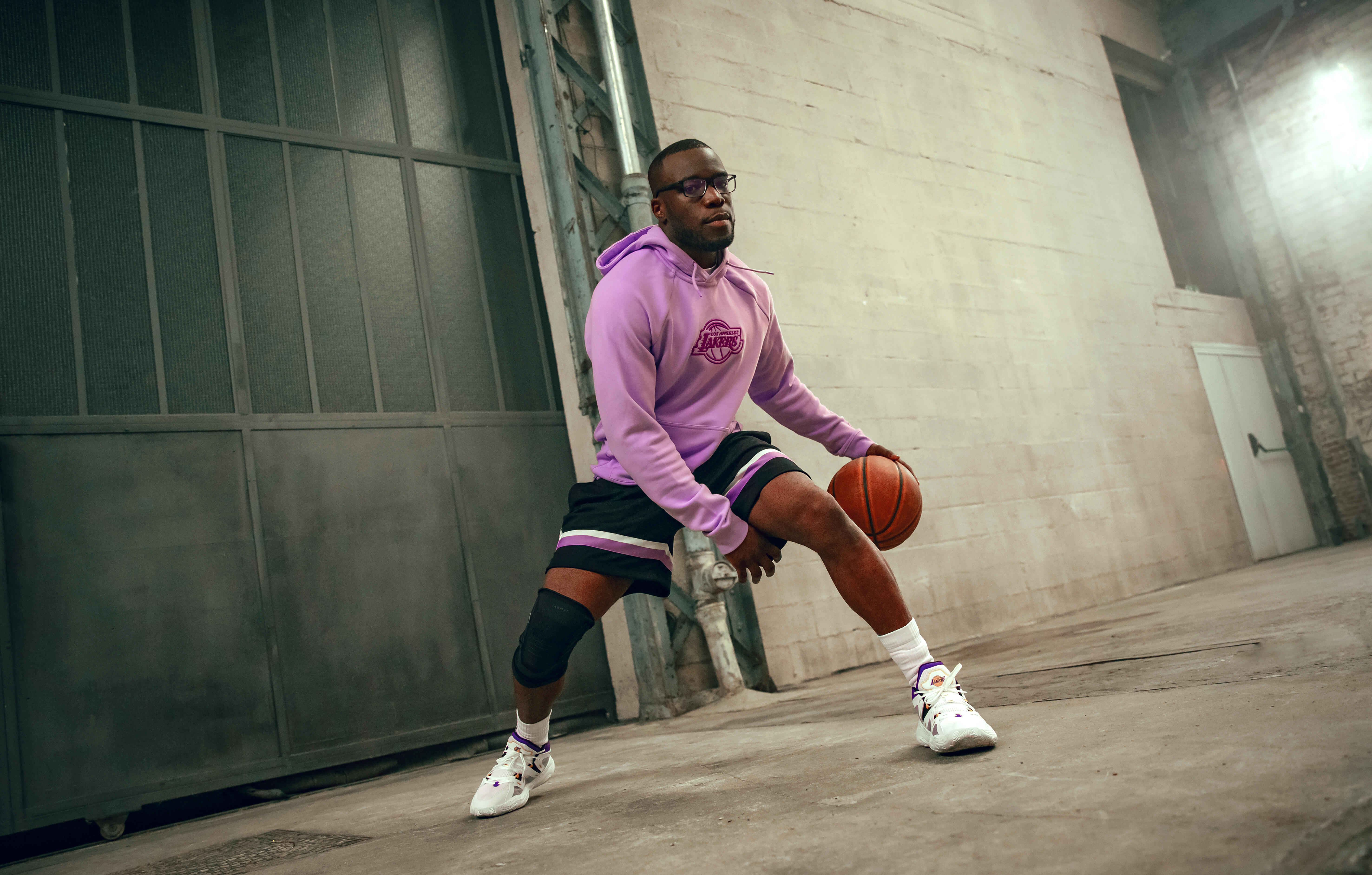 Basketball player dribbling while wearing white crew socks and basketball shoes
