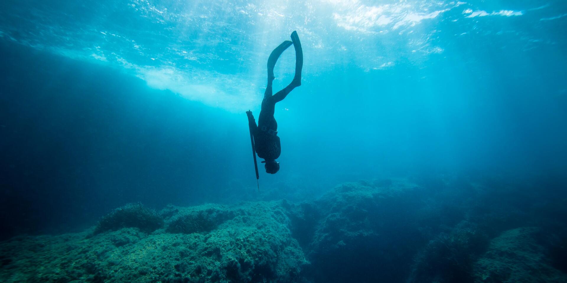 osoba w stroju nurkowym uprawiająca freediving