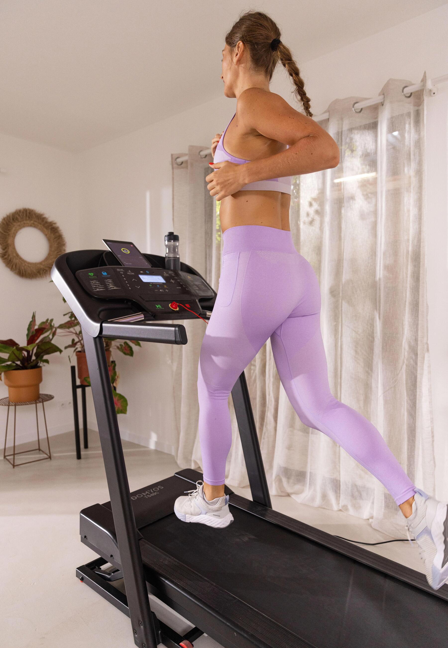 Woman running on a treadmill in her home