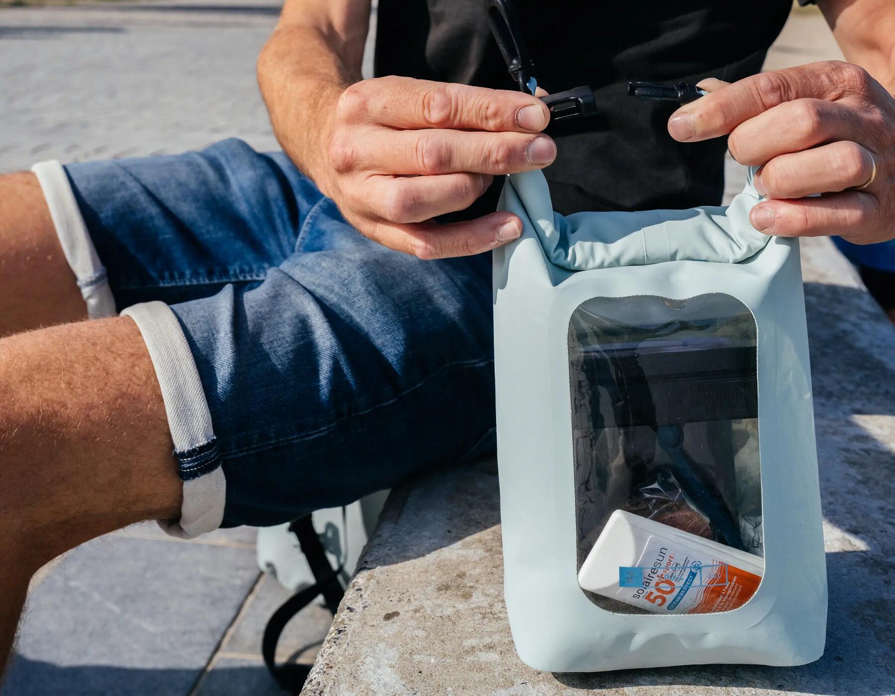 Man holding waterproof pouch