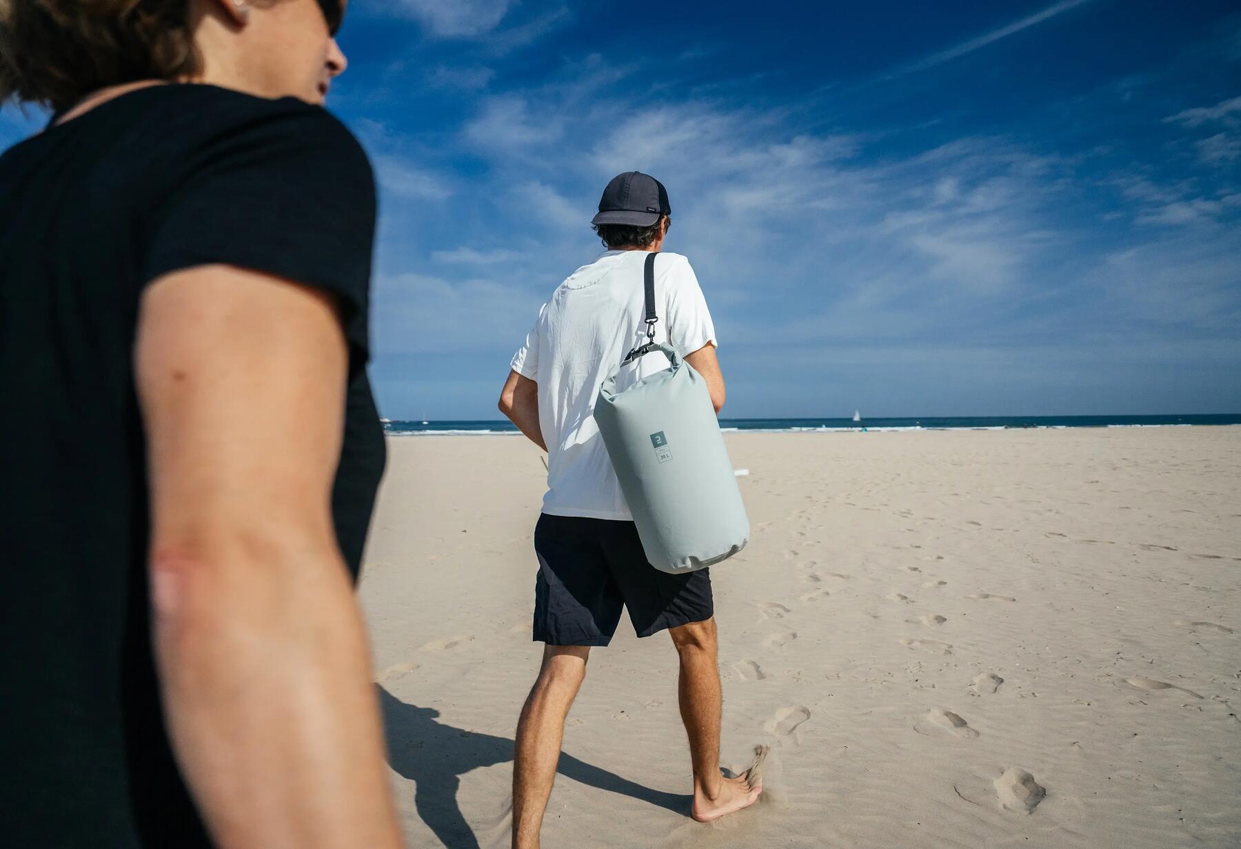 Man carrying dry bag on his back.