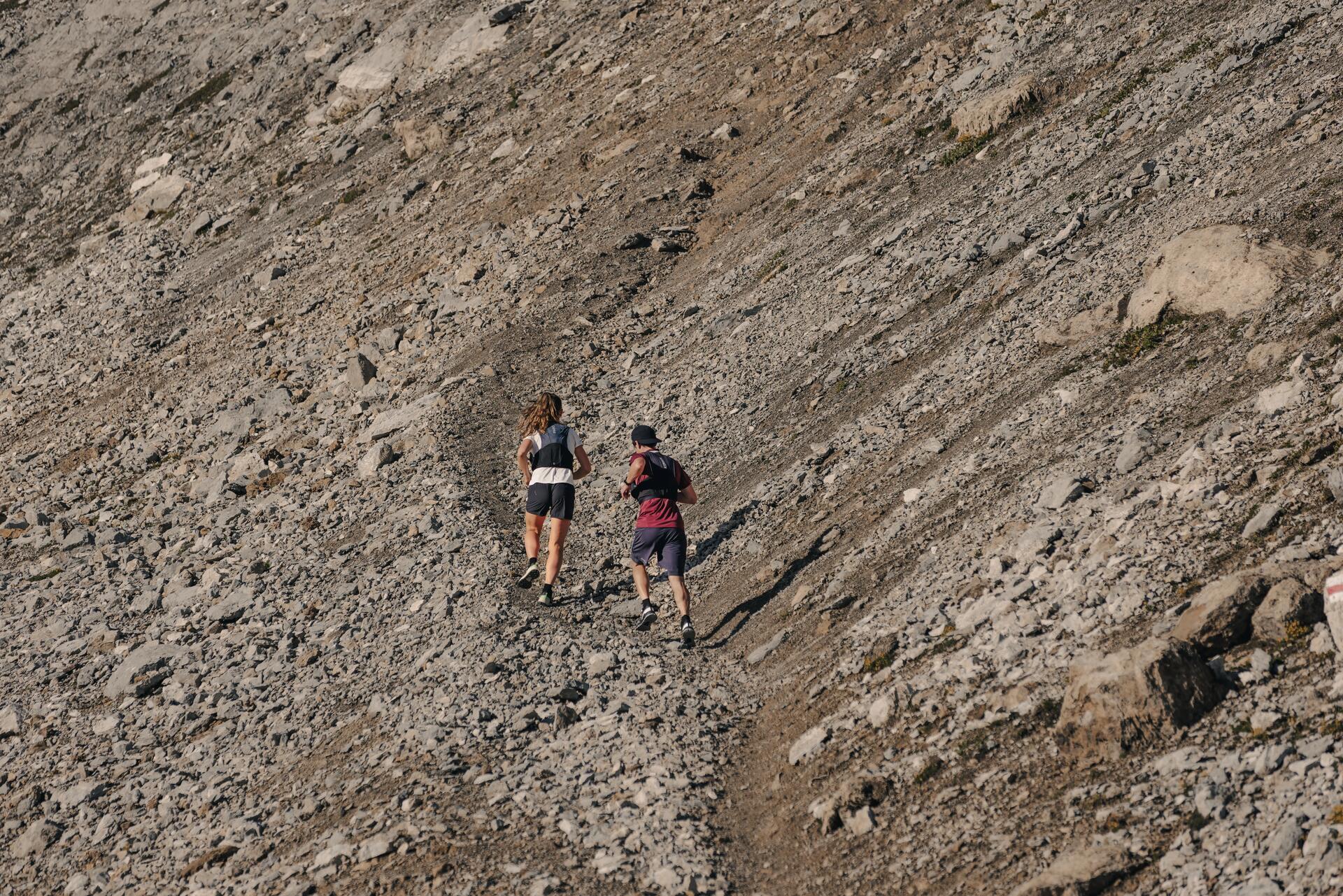 A man trail running in some hills and mountains
