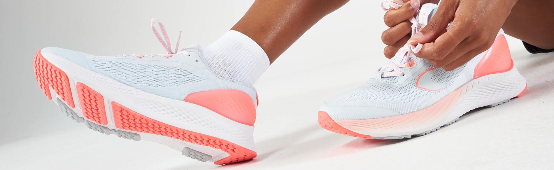 A woman tying the laces of her running shoes