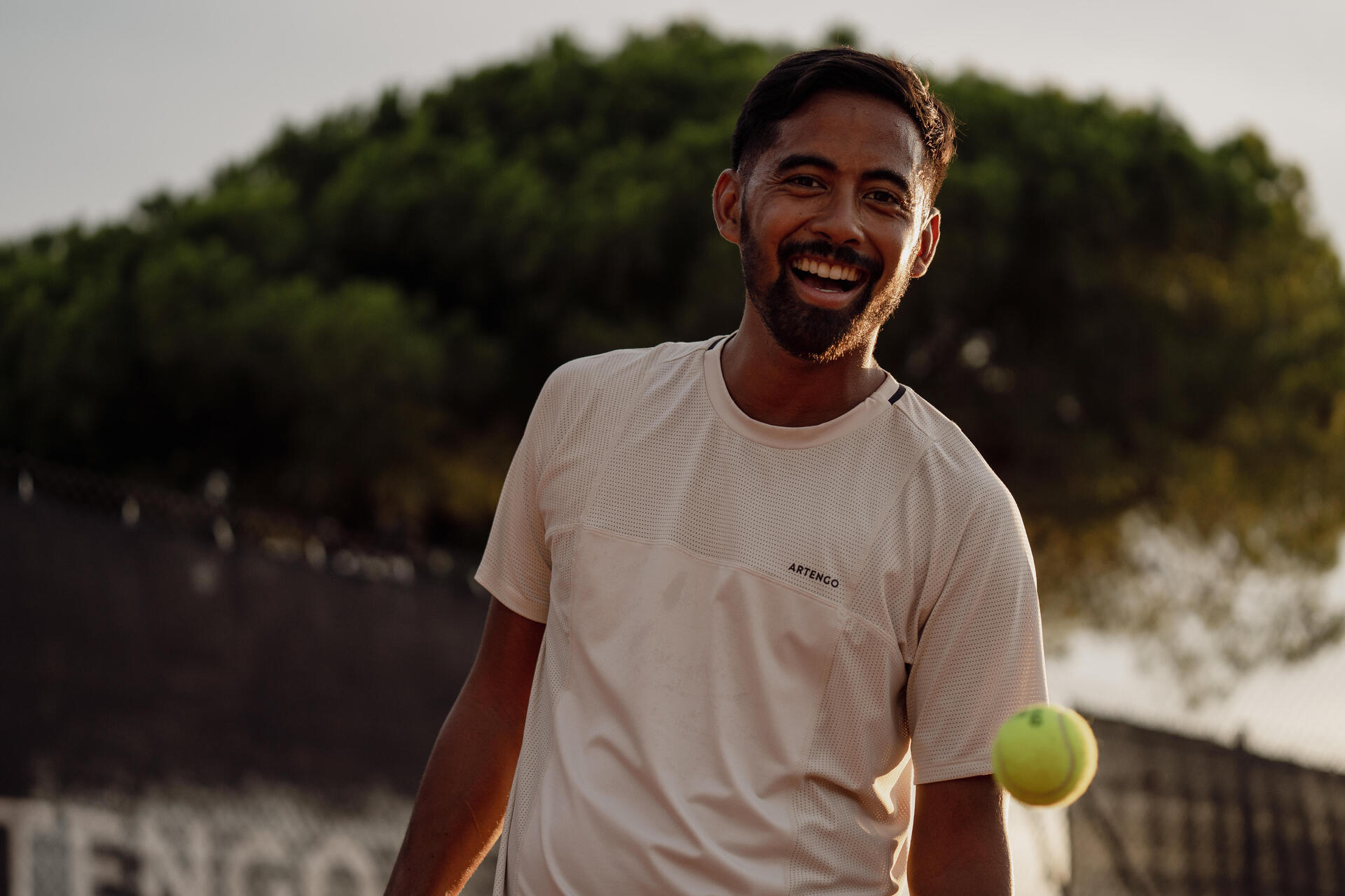 man with his tennis racket on the court