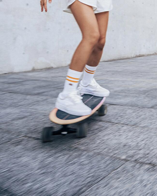 Patinadora surfeando en asfalto