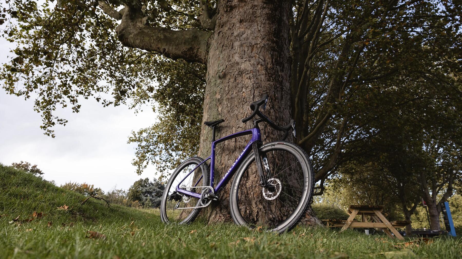 three cyclists talking as they take a break