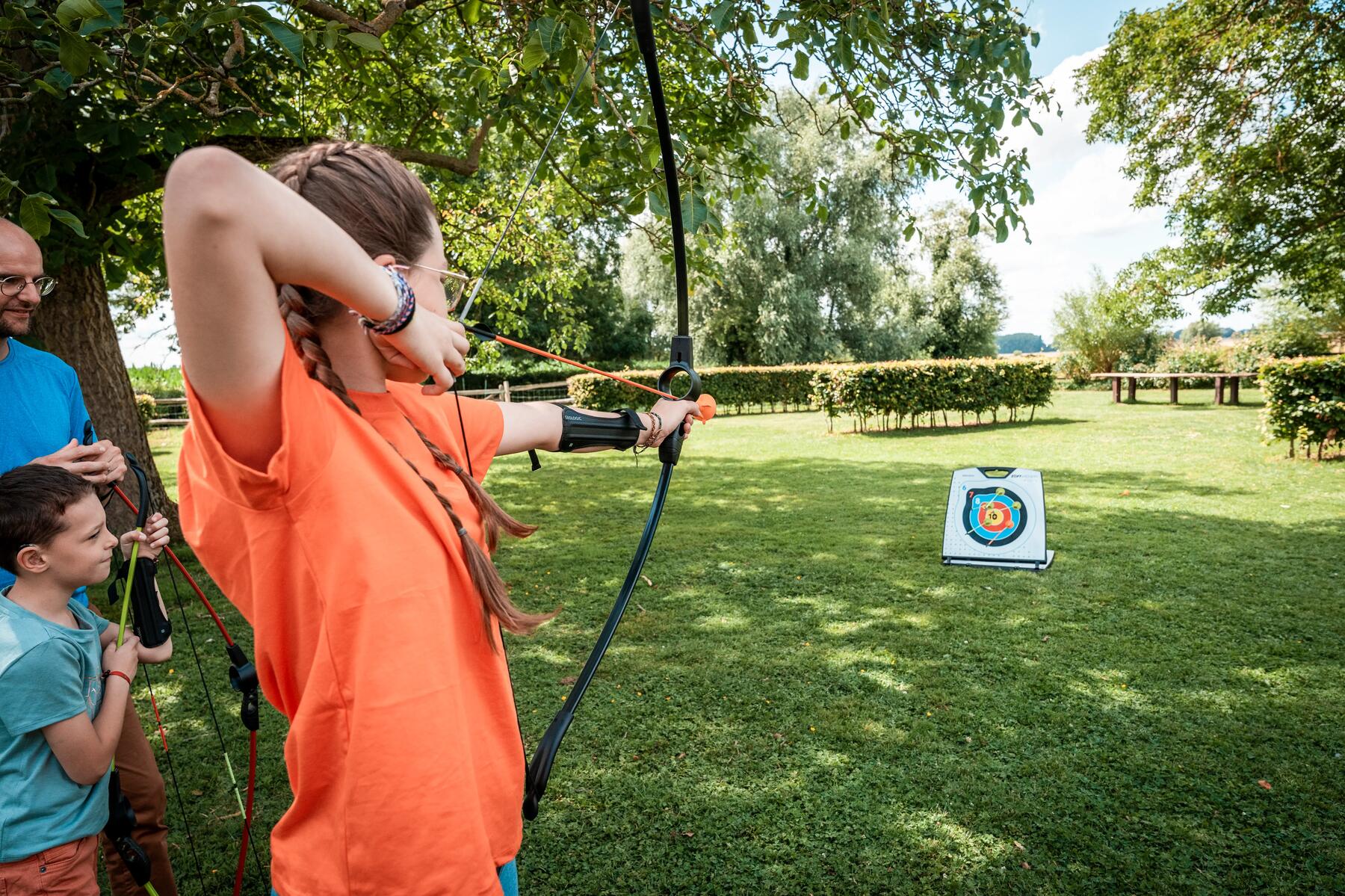 a mother and her son are archery enthusiasts