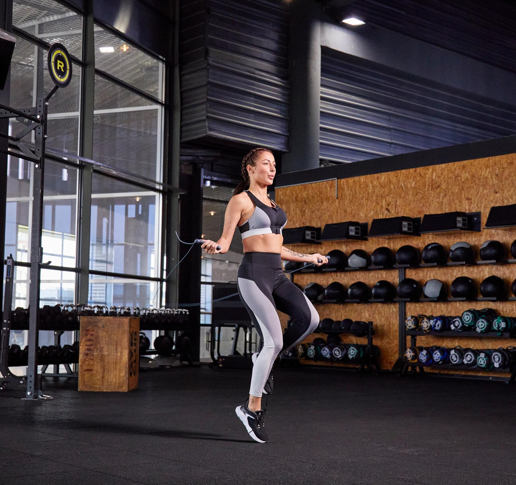 Woman skipping with a jump rope in a gym
