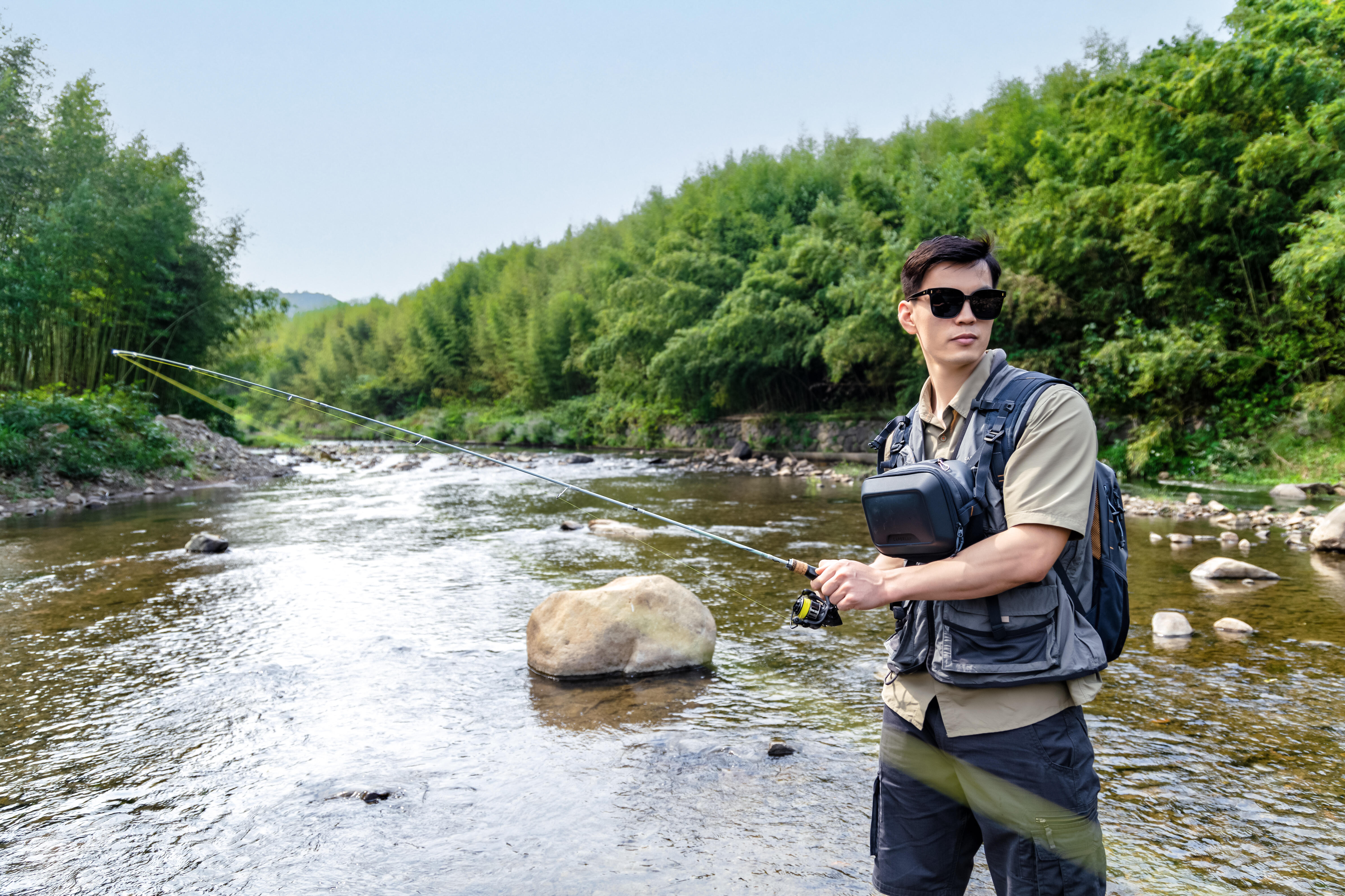Angler wearing a fishing vest while fishing in a river