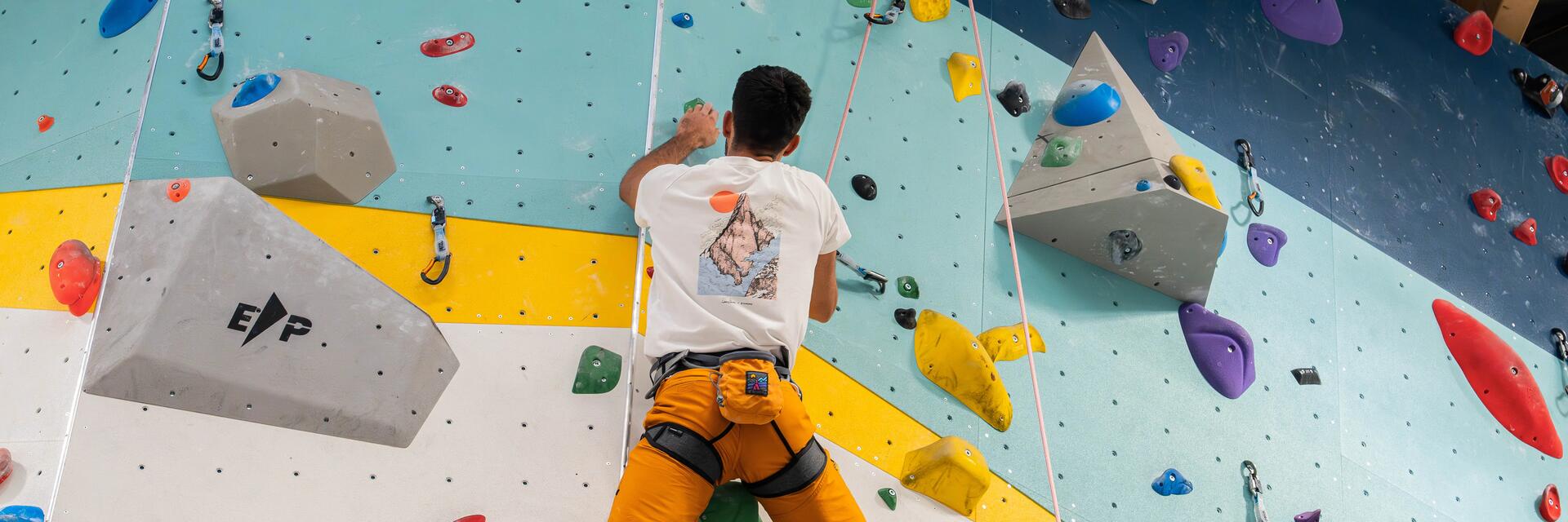 man doing indoor climbing
