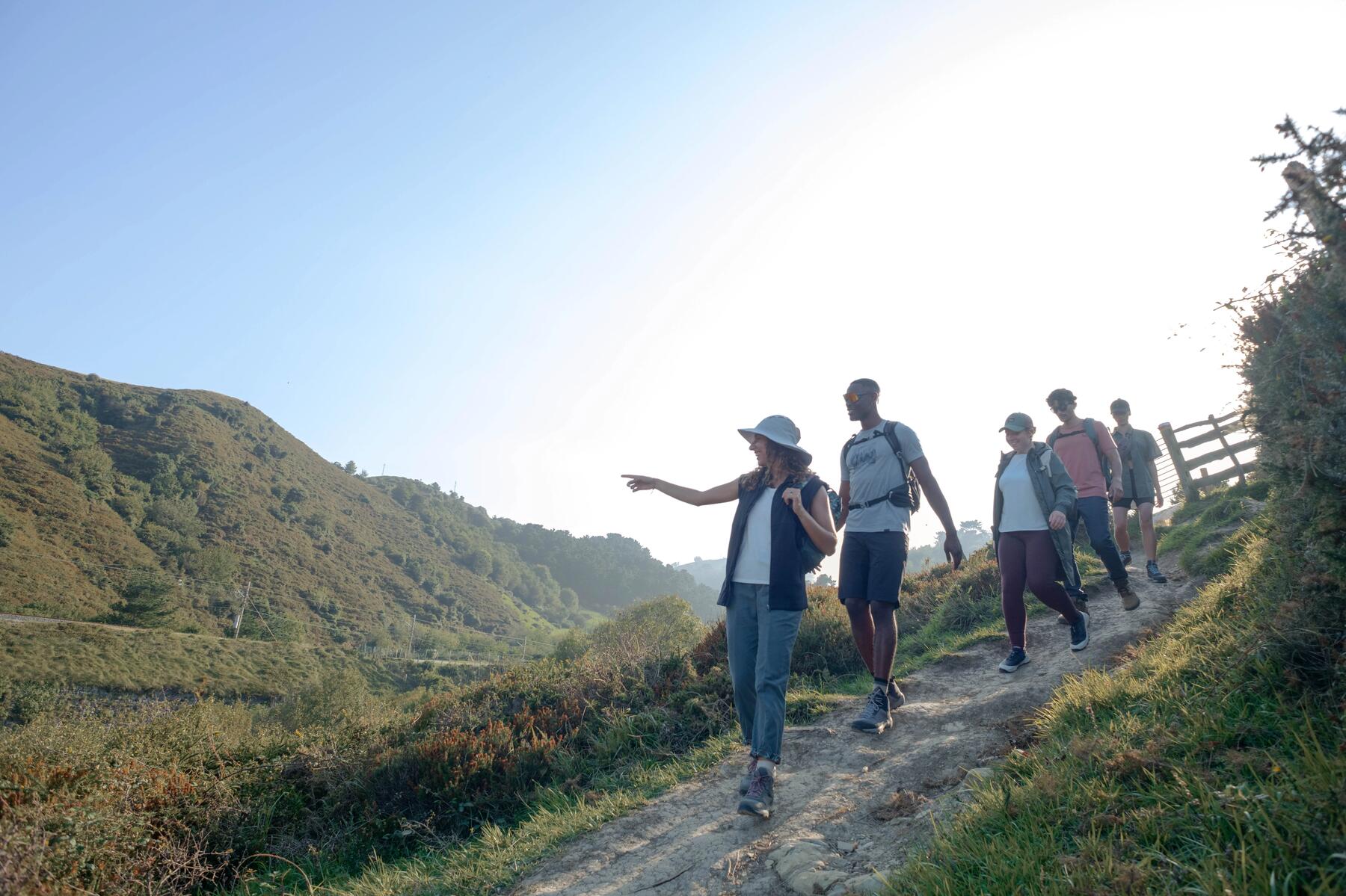 Turyści w odzieży trekkingowej idący szlakiem górskim 