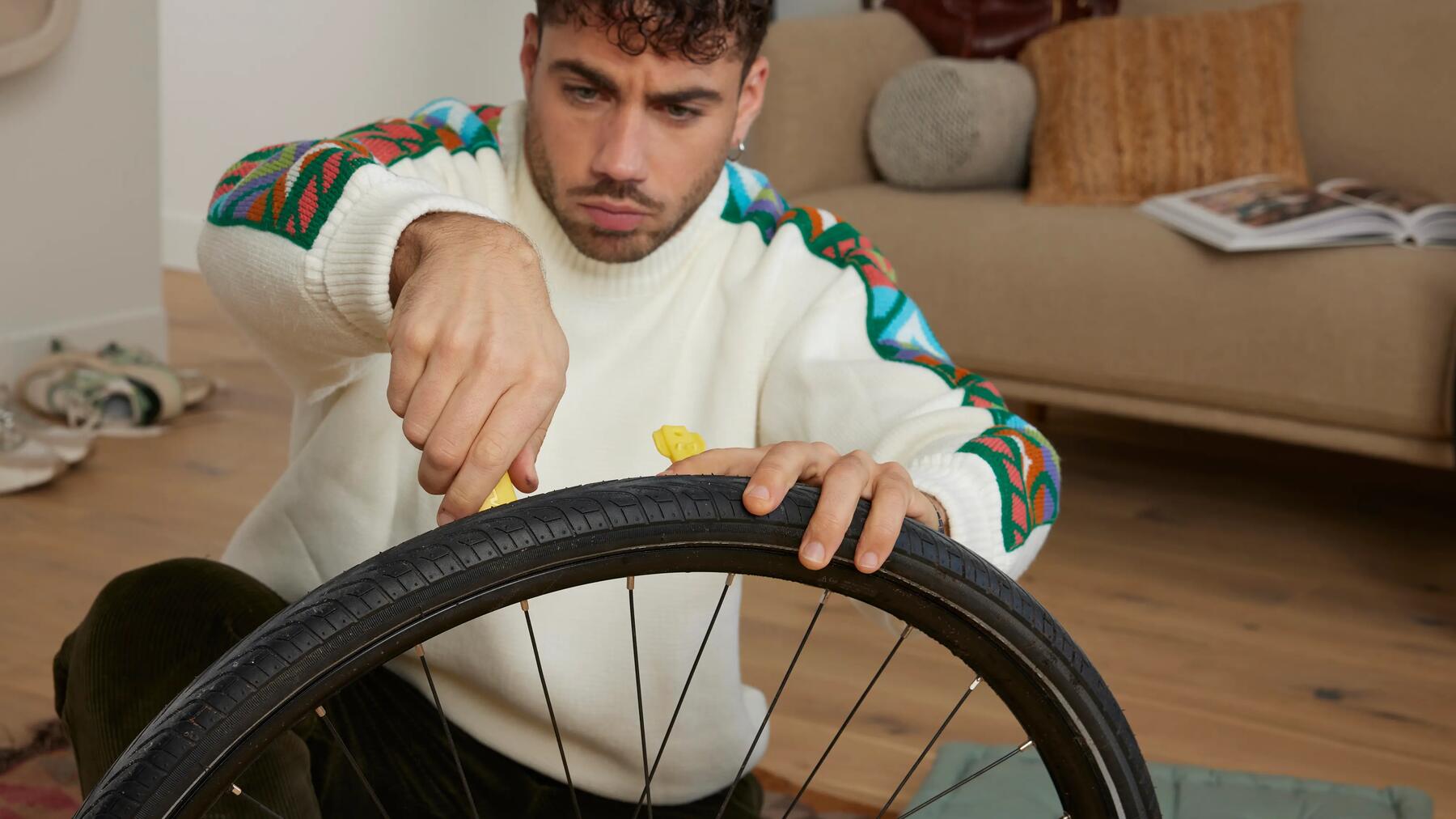 Man deflating a bike tyre