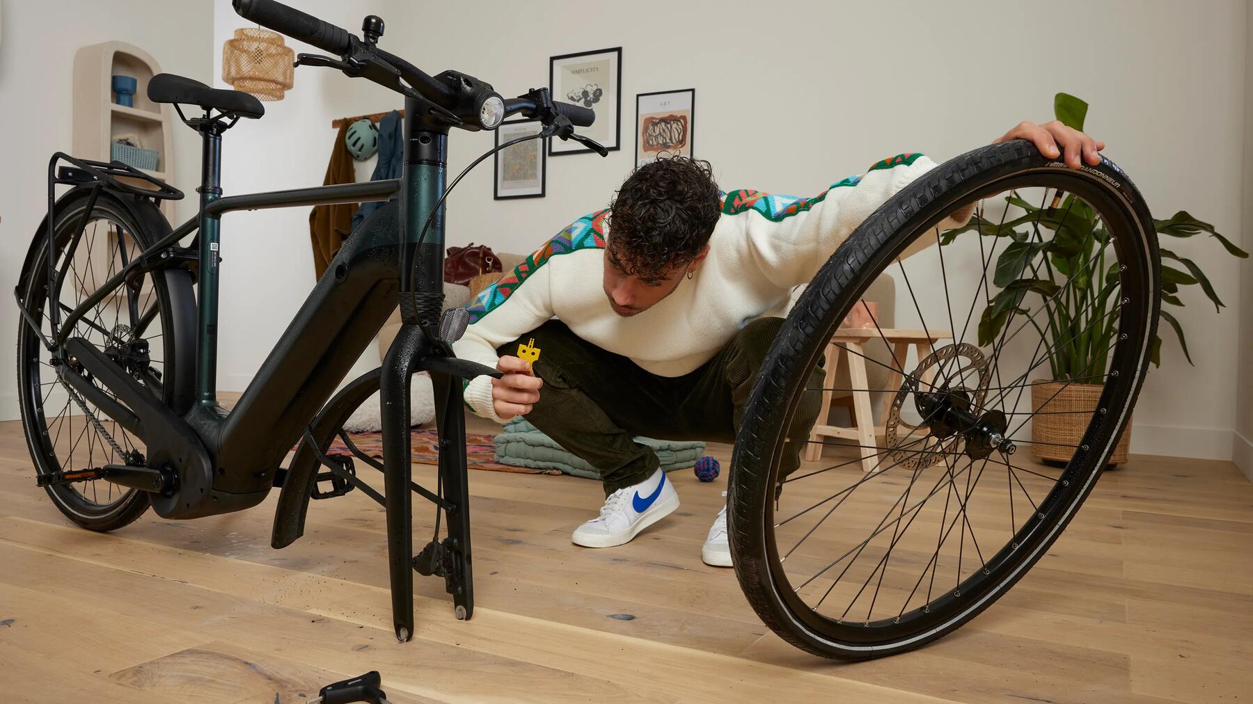 Man removing a bike wheel from its frame
