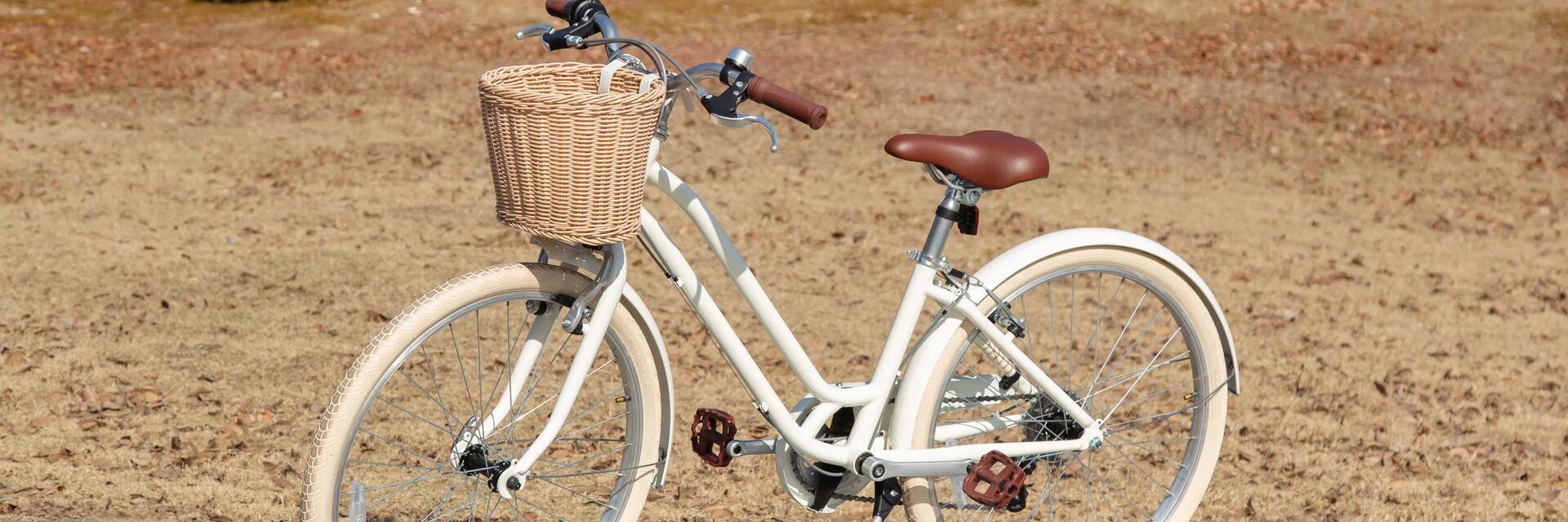 White bike with a front wicker basket