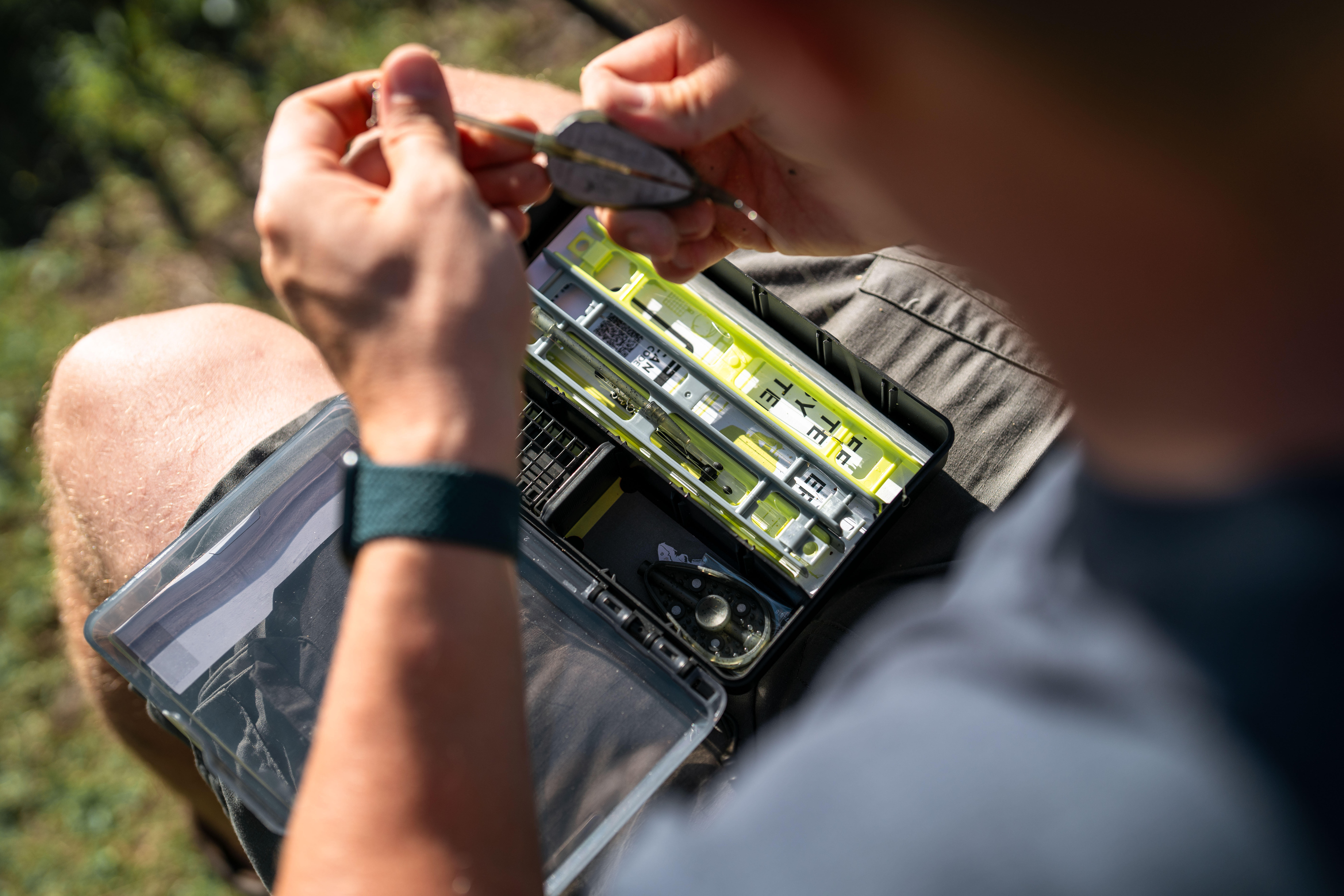 Angler preparing a fishing rig from a tackle box