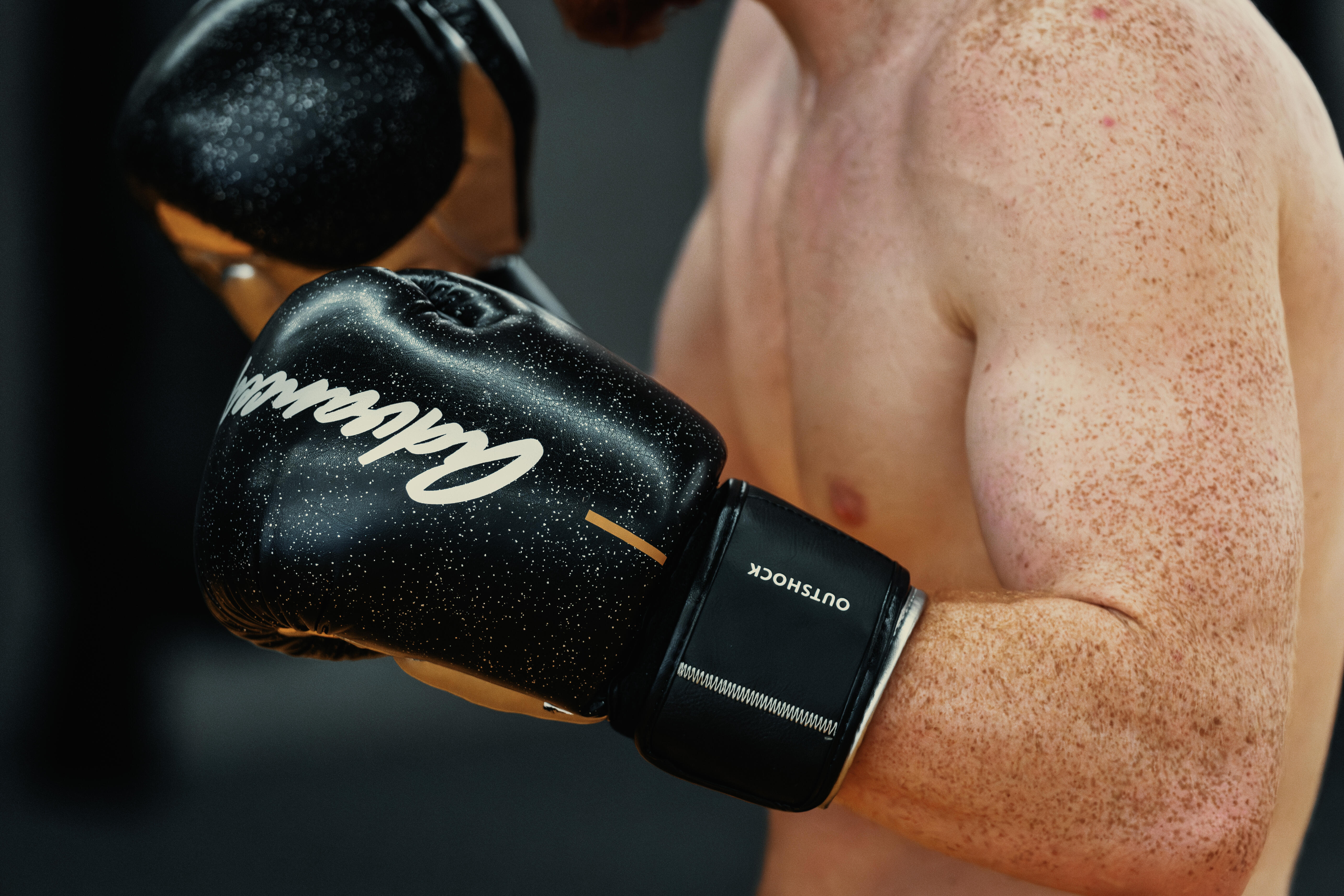 Boxer wearing black boxing gloves during training