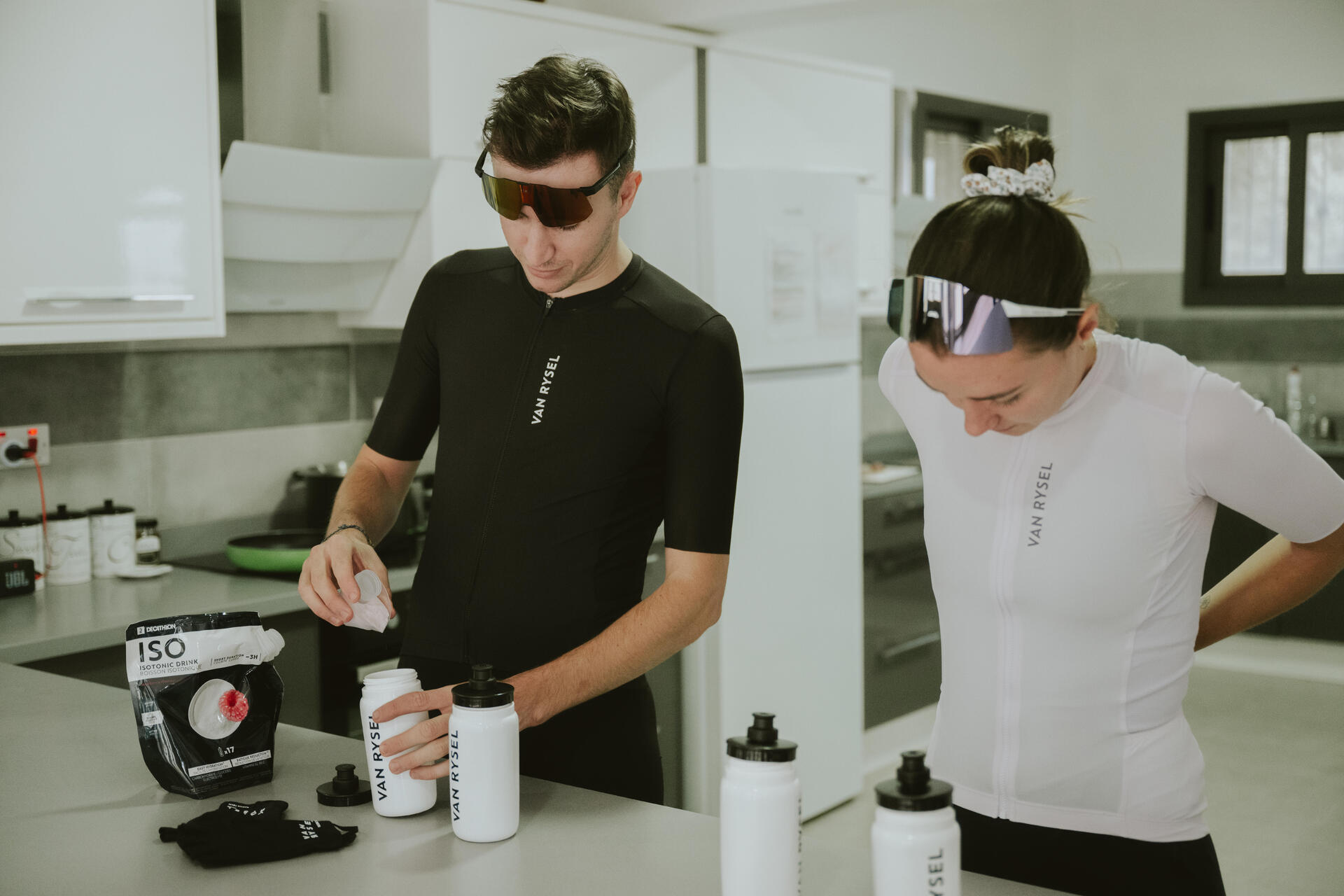 Cyclist pouring and electrolyte drink
