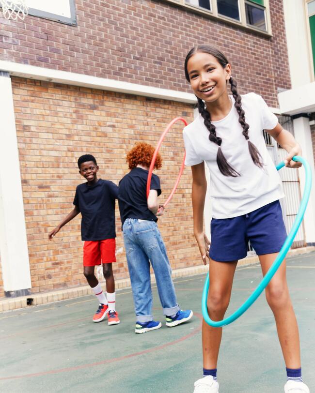 Ein Mädchen übt mit einem Gymnastikreifen.