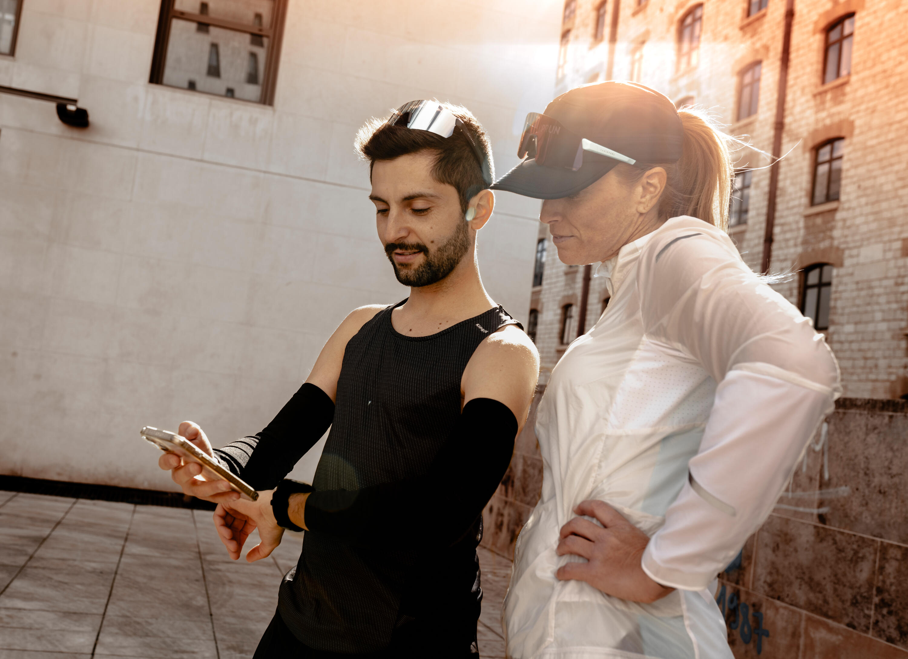  Two runners looking at a phone.