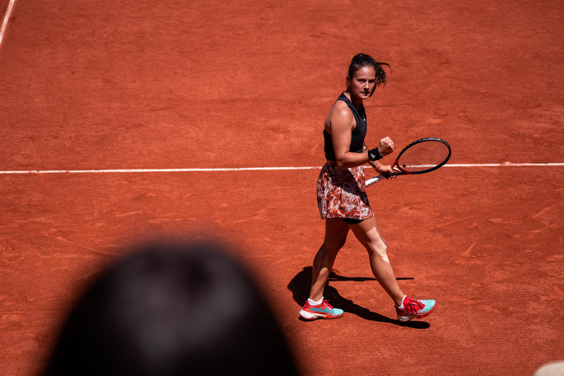woman with her tennis racket on the court