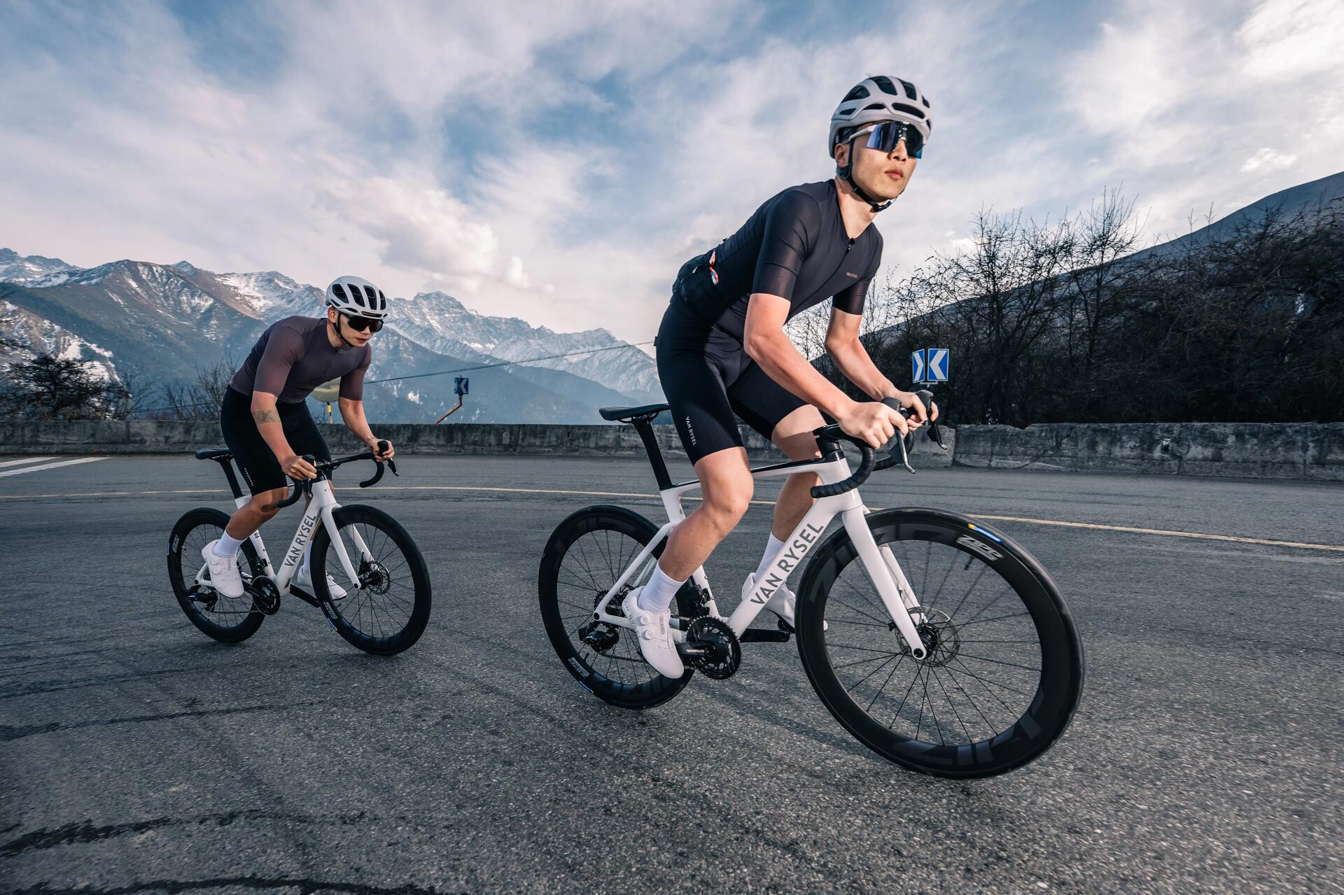 Two cyclists riding Van Rysel bikes