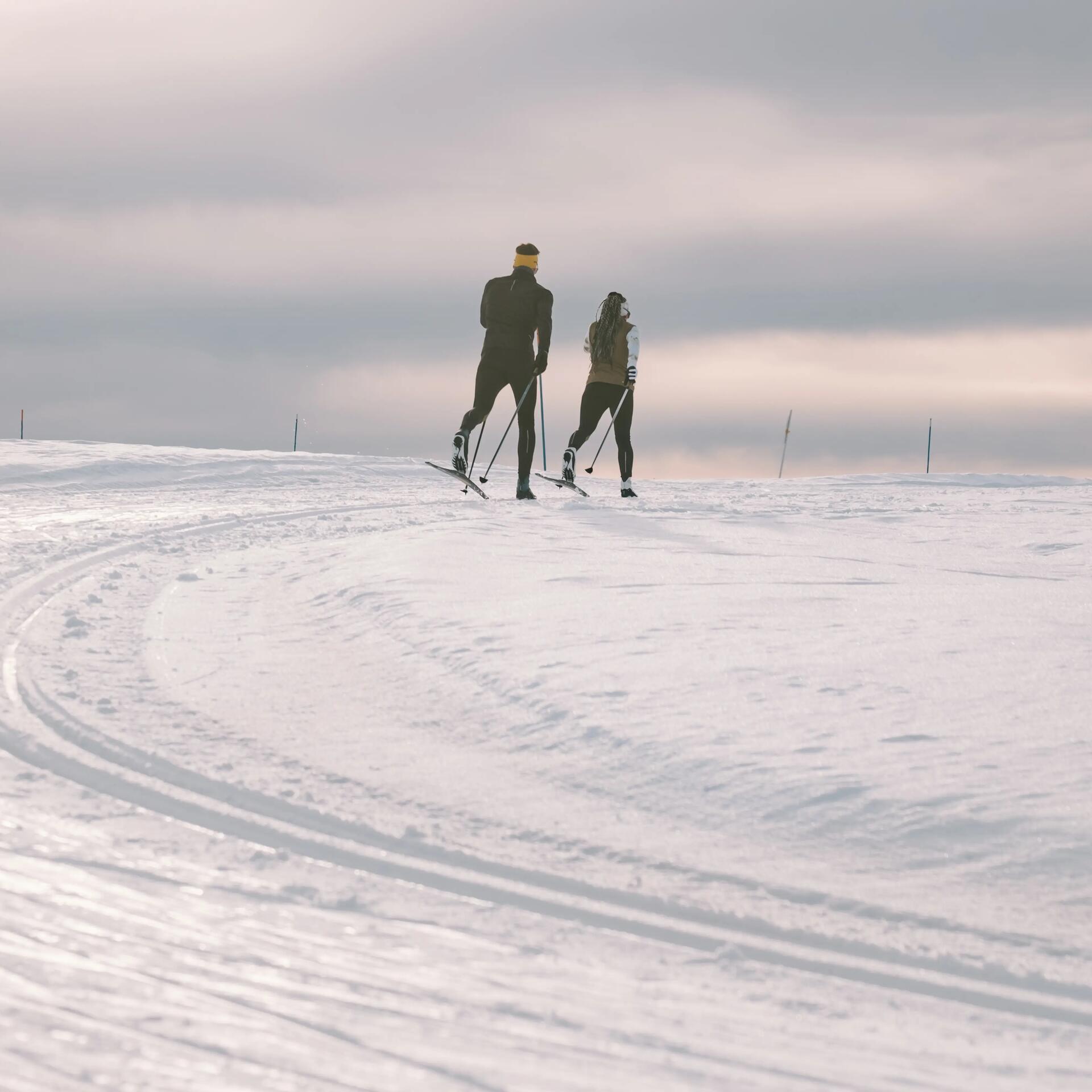 man and woman cross-country skiing decathlon