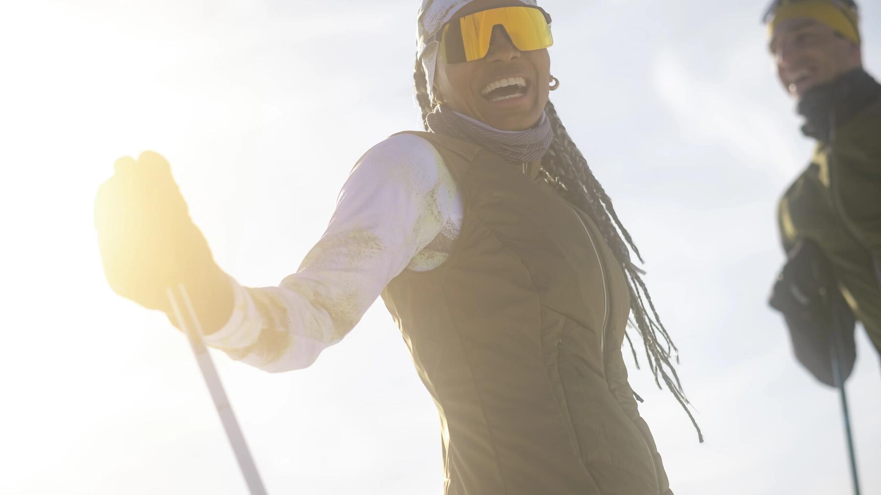 women smiling while skiing