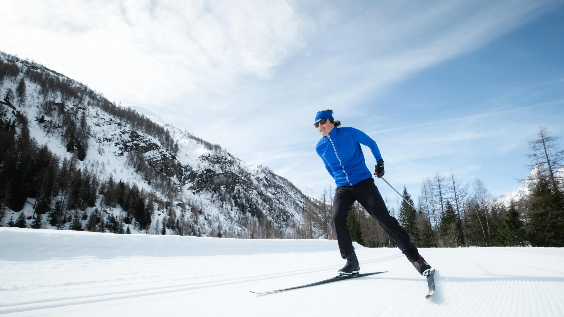 person going uphill on cross-country skis