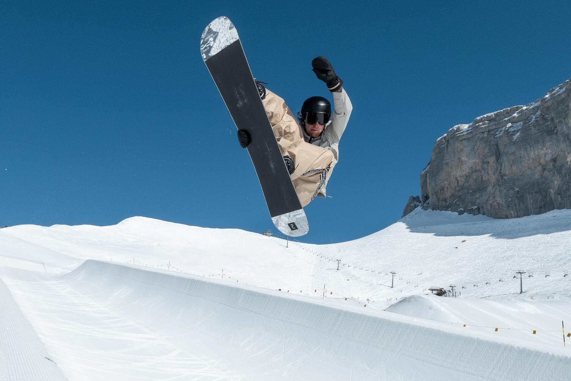 Mężczyzna uprawiający snowboard z pełnym ubezpieczeniem narciarskim