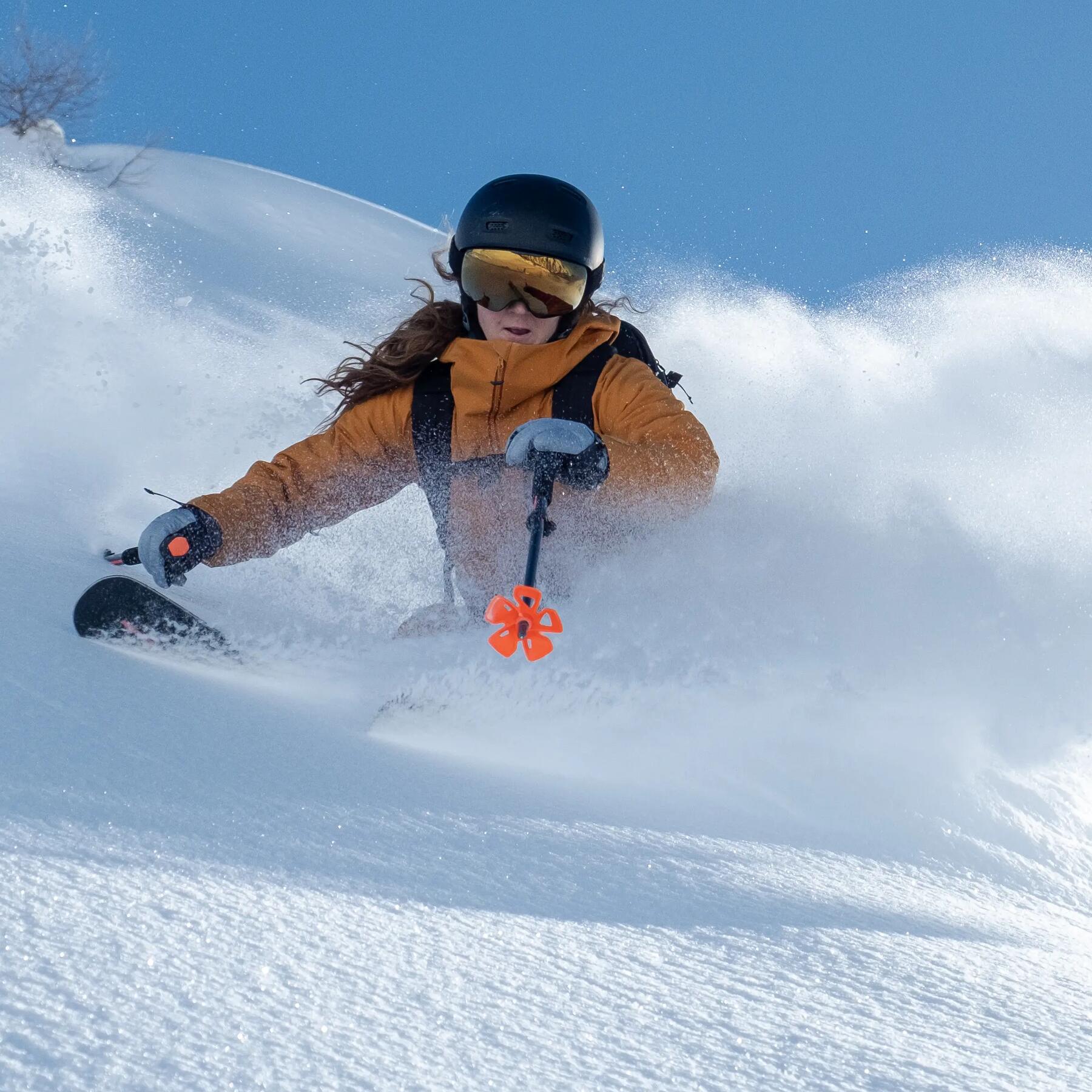 Woman freeride skiing with Decathlon freeride ski pole