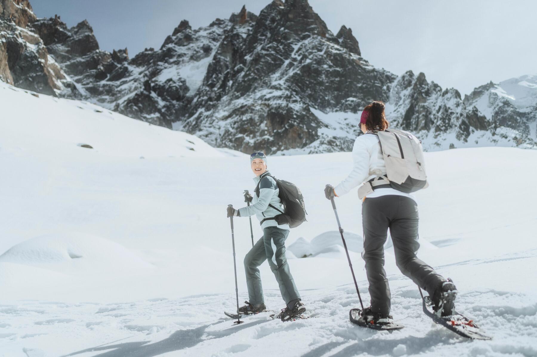 A couple taking advantage of the beautiful day to go snowshoe hiking