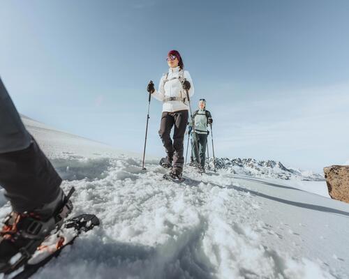 Two women on snowshoes contemplating nature