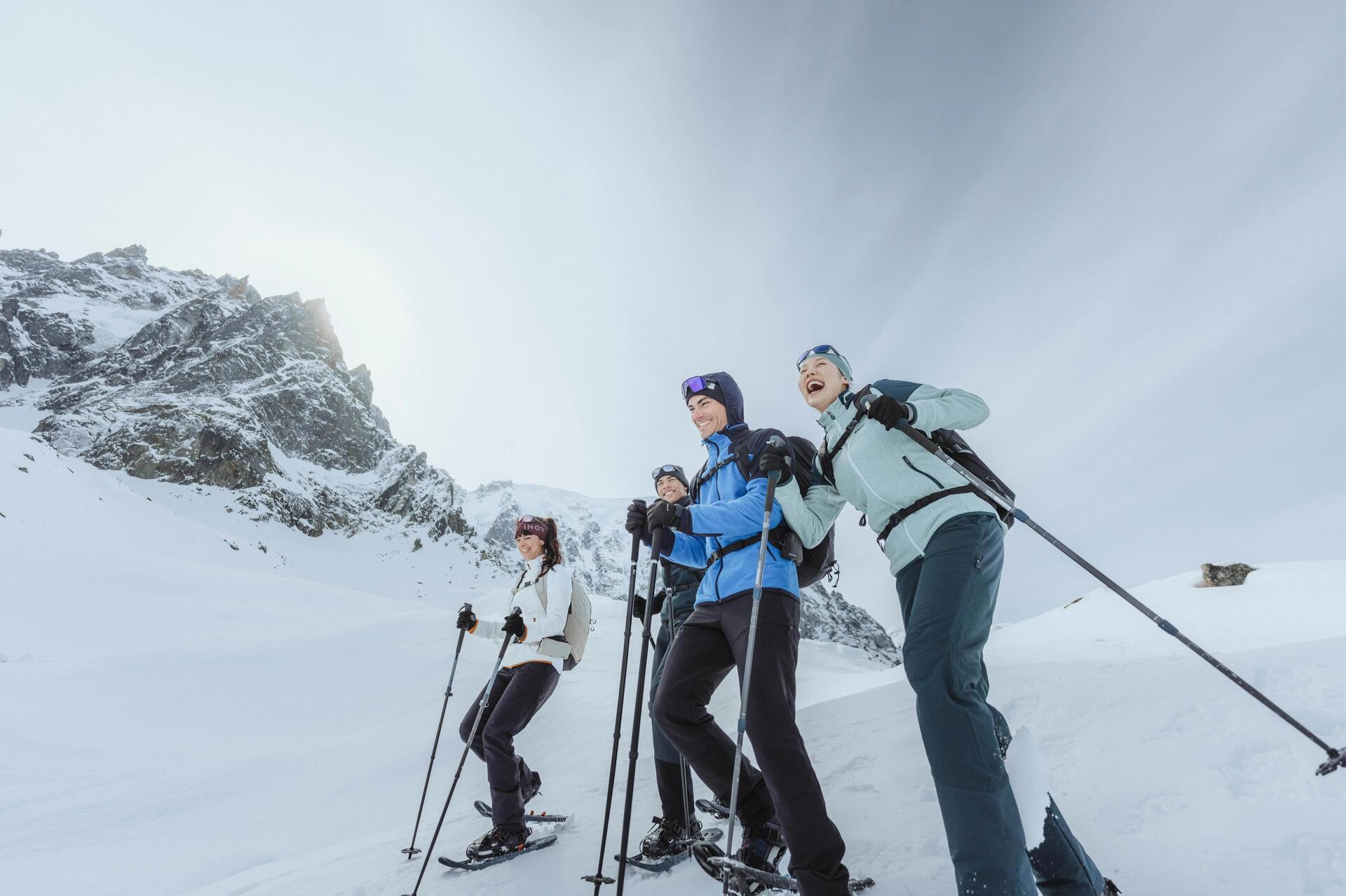 people jumping while wearing snowshoes