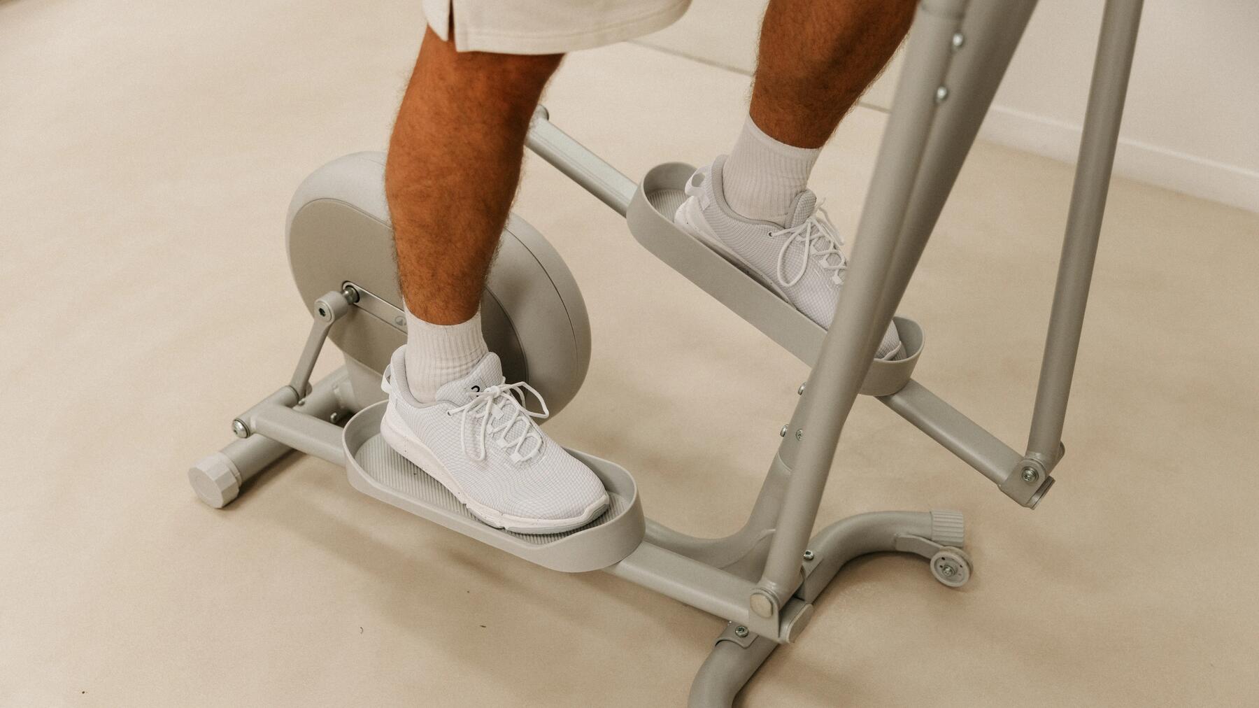 Ein Mann trainiert regelmäßig auf dem Crosstrainer