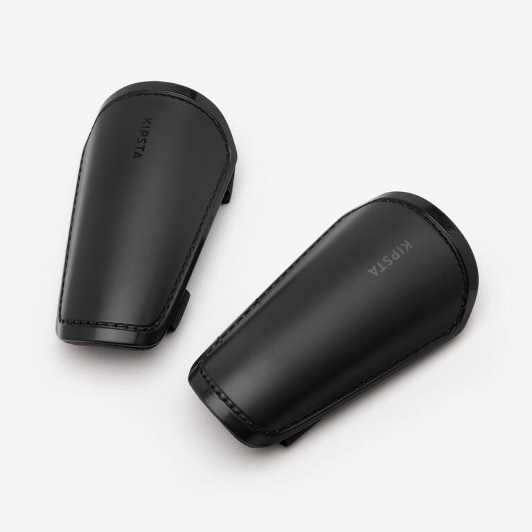 Pair of simple black kids football shin pads