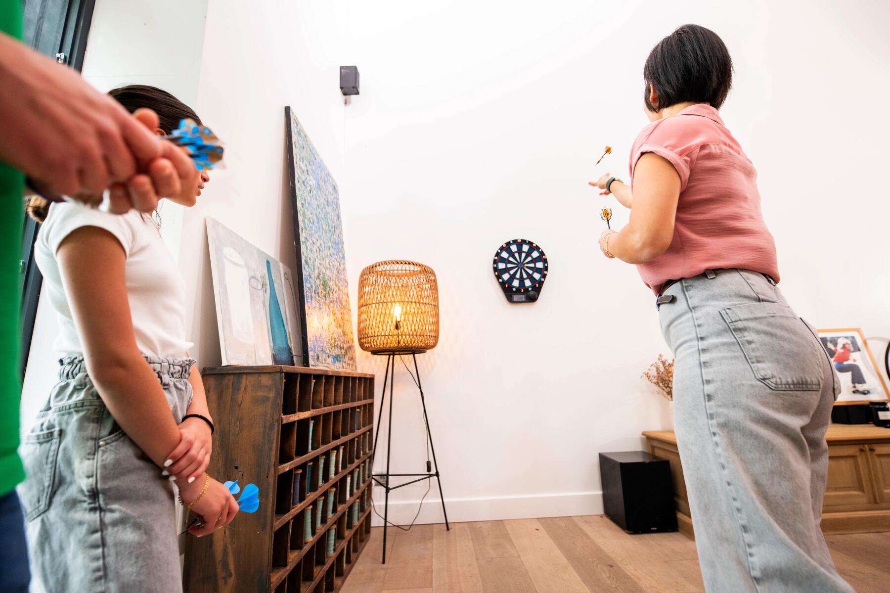 Friends who play darts for concentration and fun